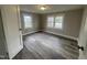 This bedroom features a spacious layout, two windows, and new flooring at 804 S Sampson Ave, Dunn, NC 28334
