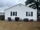 Exterior side view of a white house with black shutters at 804 S Sampson Ave, Dunn, NC 28334
