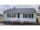 Charming one-story home with a white exterior, black shutters, and a well-maintained front yard at 804 S Sampson Ave, Dunn, NC 28334