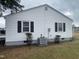 Exterior side view of a white house with black shutters and an AC unit at 804 S Sampson Ave, Dunn, NC 28334