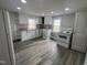 Bright kitchen featuring modern luxury vinyl plank flooring, white cabinets, and a window at 804 S Sampson Ave, Dunn, NC 28334