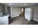 Kitchen with new modern luxury vinyl plank flooring, pantry, and new white appliances at 804 S Sampson Ave, Dunn, NC 28334