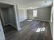 Room with new floors, neutral paint, a window, and adjacent access at 804 S Sampson Ave, Dunn, NC 28334