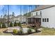 A large backyard featuring a patio, fire pit, screened porch, and wooded area at 8816 Knights Union Way, Wake Forest, NC 27587