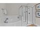 Bathroom featuring a soaking tub with subway tile surround and a frameless glass enclosed shower at 8816 Knights Union Way, Wake Forest, NC 27587