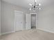 Bedroom featuring carpet, two doors, and a modern chandelier at 8816 Knights Union Way, Wake Forest, NC 27587