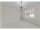 Bedroom featuring a chandelier, window, and neutral wall-to-wall carpet at 8816 Knights Union Way, Wake Forest, NC 27587
