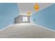 Large bonus room featuring slanted ceilings, grey accent wall, and modern light fixtures at 8816 Knights Union Way, Wake Forest, NC 27587