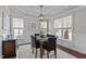 Dining room with modern table set, stylish decor, and large windows with natural light at 8816 Knights Union Way, Wake Forest, NC 27587