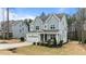Charming two-story home with a manicured front yard, inviting porch, attached garage, and modern gray siding at 8816 Knights Union Way, Wake Forest, NC 27587