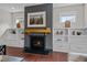 Close up view of a modern fireplace with built-in shelving and drawers on either side at 8816 Knights Union Way, Wake Forest, NC 27587