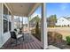 Inviting front porch with chairs, a small table, rug and manicured landscaping at 8816 Knights Union Way, Wake Forest, NC 27587