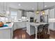 Bright kitchen featuring modern white cabinets, stainless steel appliances, and large center island at 8816 Knights Union Way, Wake Forest, NC 27587