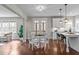 Open concept kitchen and breakfast area featuring a white table, pendant lighting, and access to outdoor space at 8816 Knights Union Way, Wake Forest, NC 27587