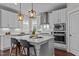 Bright kitchen with modern white cabinets, stainless steel appliances, and large center island at 8816 Knights Union Way, Wake Forest, NC 27587