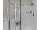 Shower in bathroom featuring subway tile surround, glass door, and built-in shower caddy at 8816 Knights Union Way, Wake Forest, NC 27587