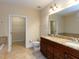 Bathroom with double vanity, soaking tub, and walk-in closet at 9221 Calabria Dr # 121, Raleigh, NC 27617