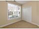 Bright bedroom featuring a window with blossoming tree views and a closet at 9221 Calabria Dr # 121, Raleigh, NC 27617