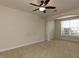 Bedroom with neutral carpeting, a ceiling fan, a large window, and an arched entry at 9221 Calabria Dr # 121, Raleigh, NC 27617