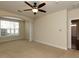 Bedroom with neutral carpeting, ceiling fan, natural light, and ample space at 9221 Calabria Dr # 121, Raleigh, NC 27617