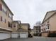 Street view of yellow two-story townhomes with red shutters and garages at 9221 Calabria Dr # 121, Raleigh, NC 27617