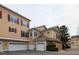 Two-story townhome featuring yellow siding, red shutters, and attached garages at 9221 Calabria Dr # 121, Raleigh, NC 27617