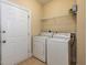 Functional laundry room with washer, dryer, and overhead shelf for storage at 9221 Calabria Dr # 121, Raleigh, NC 27617