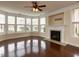 Bright living room featuring a fireplace, hardwood floors, and large windows at 9221 Calabria Dr # 121, Raleigh, NC 27617