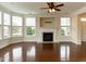 Cozy living area with fireplace, hardwood floors, and bay windows at 9221 Calabria Dr # 121, Raleigh, NC 27617