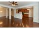 Open-concept living room and kitchen featuring hardwood floors, stainless steel appliances, and ample cabinet space at 9221 Calabria Dr # 121, Raleigh, NC 27617