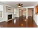 Elegant living room featuring a fireplace, hardwood floors, large windows, and decorative molding at 9221 Calabria Dr # 121, Raleigh, NC 27617