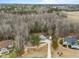 A high aerial view of the home's setting within a private, wooded lot and rural surroundings at 100 Lexington Ave, Zebulon, NC 27597