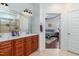 Bathroom featuring double sink vanity and an open view to the main bedroom at 100 Lexington Ave, Zebulon, NC 27597