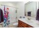 Bathroom with shower over tub, large mirror and single sink vanity at 100 Lexington Ave, Zebulon, NC 27597