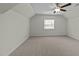 A spacious bedroom with neutral carpet, fan, and a window to let in lots of natural light at 100 Lexington Ave, Zebulon, NC 27597