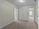 Cozy bedroom with neutral carpet, natural light, and doorway to the bonus room at 100 Lexington Ave, Zebulon, NC 27597