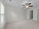 Bedroom featuring neutral carpet, ceiling fan and a white door leading to another room at 100 Lexington Ave, Zebulon, NC 27597