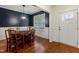 Formal dining room with navy accent wall, wainscoting and hardwood floors at 100 Lexington Ave, Zebulon, NC 27597