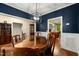 Dining area with hardwood floors, glass top table and view of kitchen area at 100 Lexington Ave, Zebulon, NC 27597