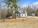 Charming two-story home featuring stone accents and a welcoming front porch at 100 Lexington Ave, Zebulon, NC 27597