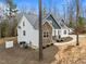 Charming two-story home featuring stone accents, white siding, and well-manicured landscaping at 100 Lexington Ave, Zebulon, NC 27597