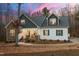 Charming two-story home featuring a stone facade, inviting front porch, and landscaped yard at 100 Lexington Ave, Zebulon, NC 27597