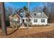 Charming two-story home featuring a stone facade and an inviting front porch at 100 Lexington Ave, Zebulon, NC 27597