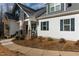 Charming two-story home featuring a stone facade, an inviting front porch, and landscaped yard at 100 Lexington Ave, Zebulon, NC 27597