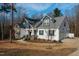 Charming two-story home featuring a stone facade, an inviting front porch, and an attached garage at 100 Lexington Ave, Zebulon, NC 27597