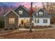 Charming two-story home featuring a stone facade and an inviting front porch at 100 Lexington Ave, Zebulon, NC 27597