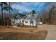 Charming two-story home featuring a stone facade, an inviting front porch, and an attached garage at 100 Lexington Ave, Zebulon, NC 27597