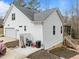 Rear exterior view showcasing white siding, a screened porch, and an attached two-car garage at 100 Lexington Ave, Zebulon, NC 27597