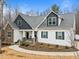 This shot shows the front of the house, highlighting the stone accents, inviting porch, and landscaped yard at 100 Lexington Ave, Zebulon, NC 27597