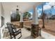 Charming front porch with stone base columns and comfortable rocking chairs create a welcoming entry at 100 Lexington Ave, Zebulon, NC 27597